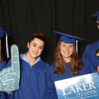 four friends using props at the photo booth